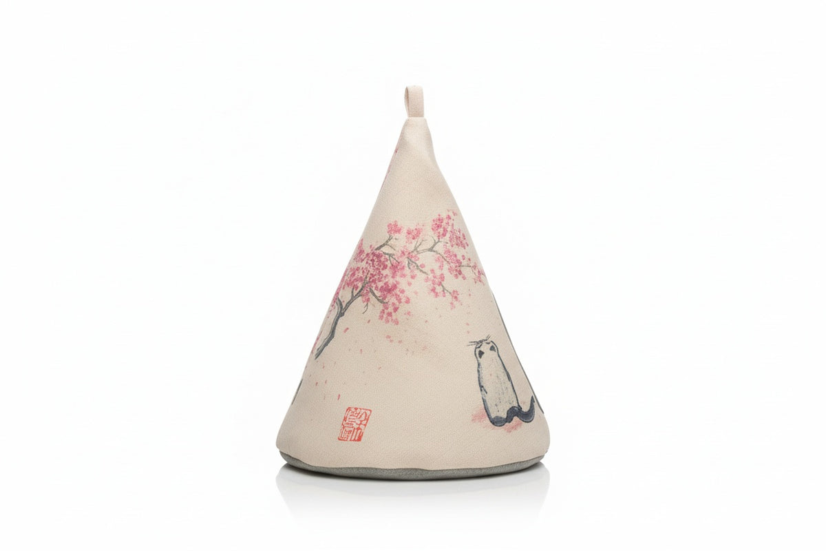 Decorative cone-shaped pillow with cherry blossom and cat design on a white background